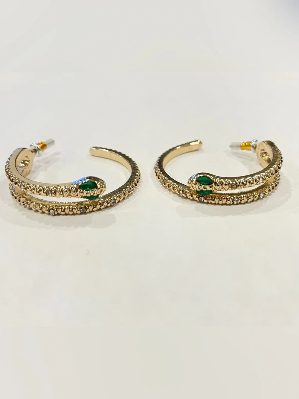 Gold Sparkle Snake Hoop Earrings with Green Eye Stone Accents